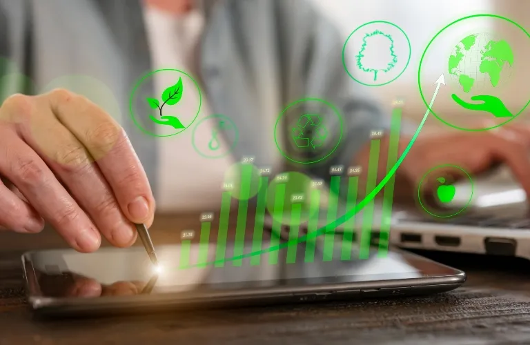 Person using a stylus on a tablet with green eco-friendly icons and upward graph overlay.